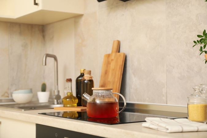 Modern kitchen interior with different supplies in light colors