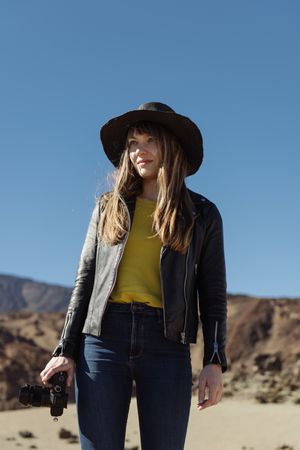 Woman with camera in desert
