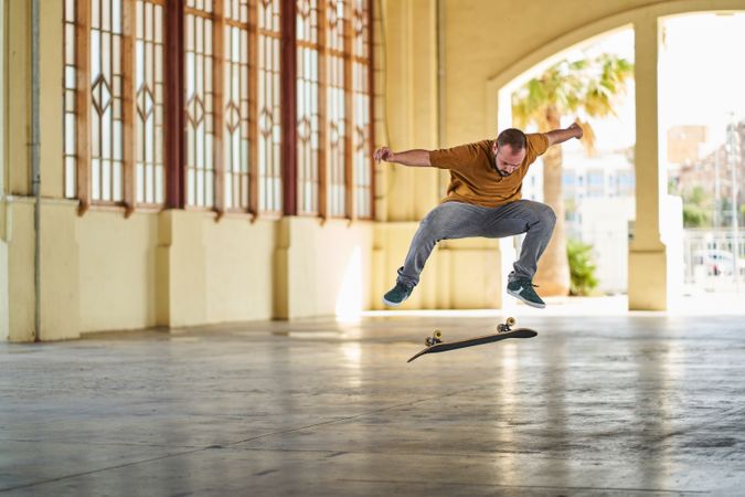 Young man doing an ollie flip on his skateboard