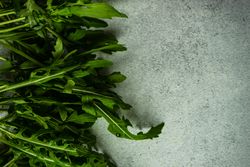Close up of arugula leaves on grey counter