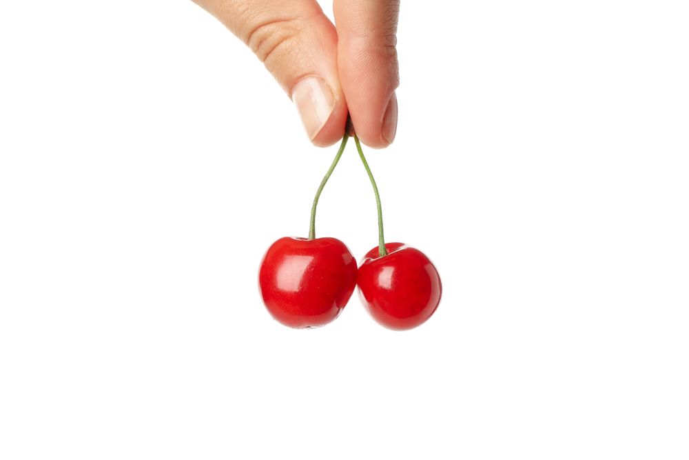 Fresh red cherry isolated on blank background