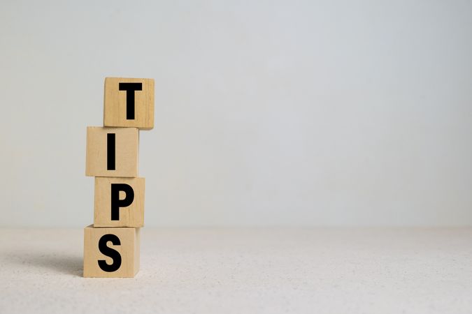 tips word on stack wooden blocks on light background