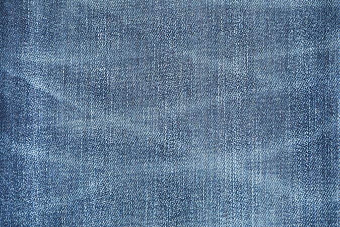 Texture of blue jeans as background, space for text
