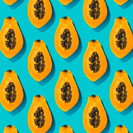 Papaya halves pattern on a pastel blue background