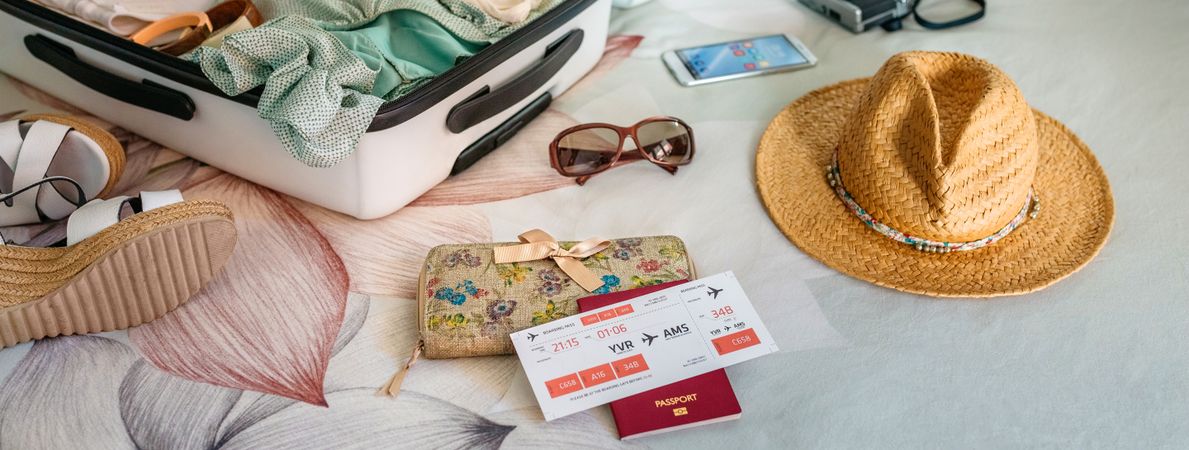 Unrecognizable woman preparing suitcase for summer holidays