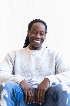 Black man with dreadlocks smiling widely