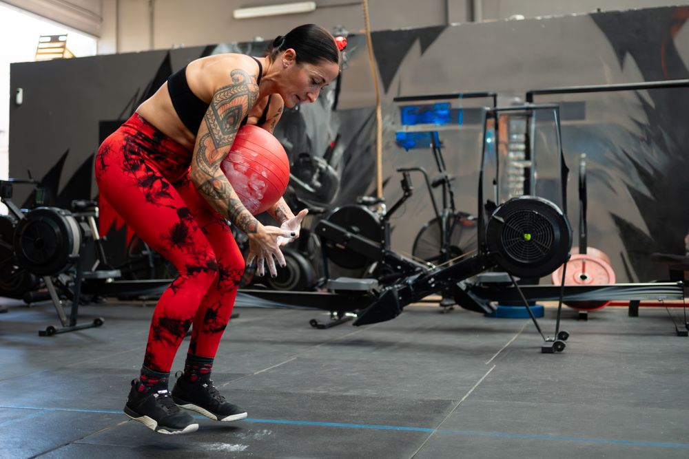 Woman exercising with medicinal ball in a gym