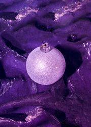 Christmas bauble decoration on purple cloth