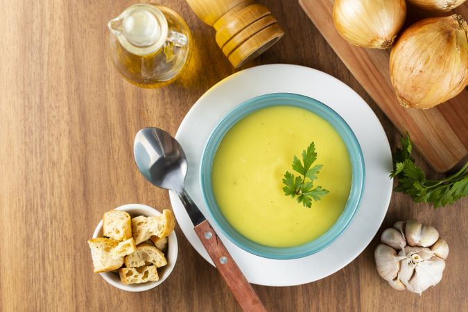 Bowl with onion soup and croutons on the table.