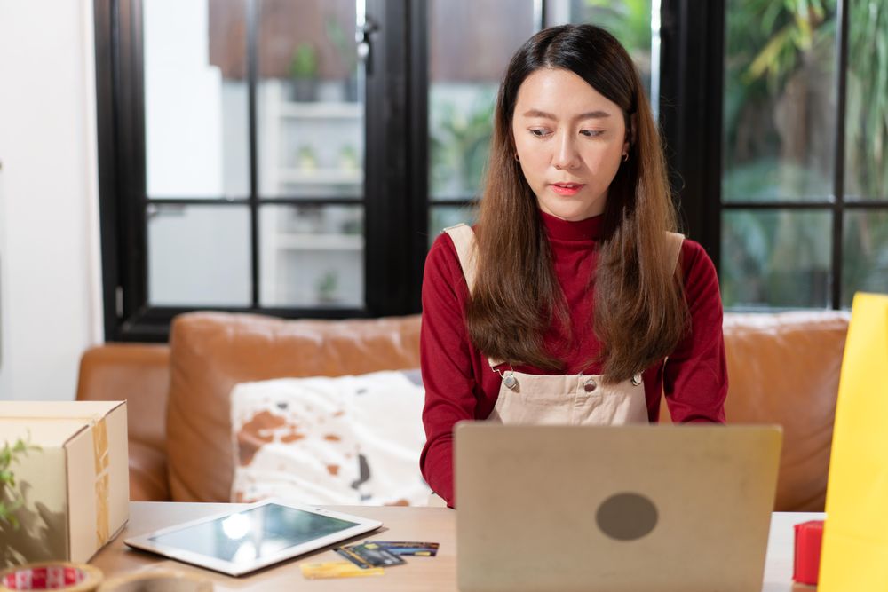Female working at online e-commerce store at home