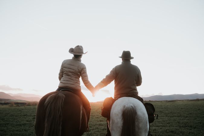 People on horses holding hands