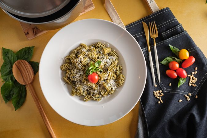 Delicious radiatori with cheese in plate on table