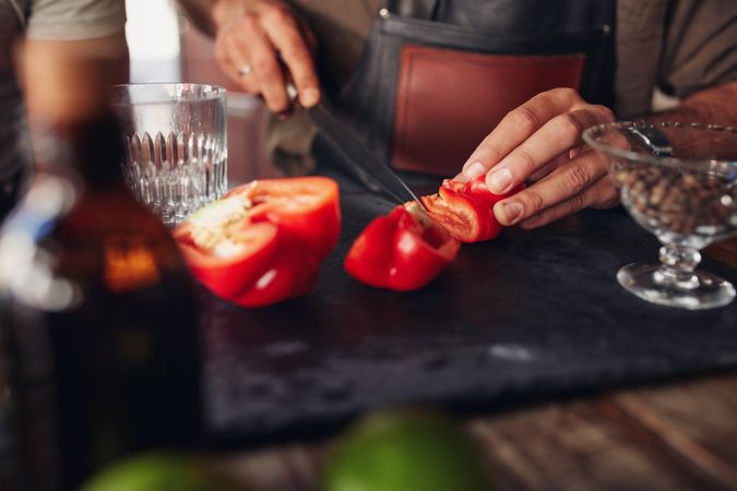 Close up shot of bartender hands chopping red bell pepper