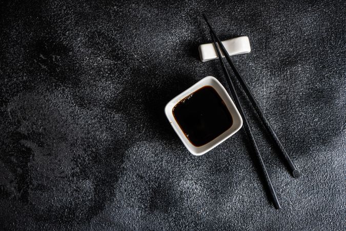 Asian table setting with chopsticks on dark background