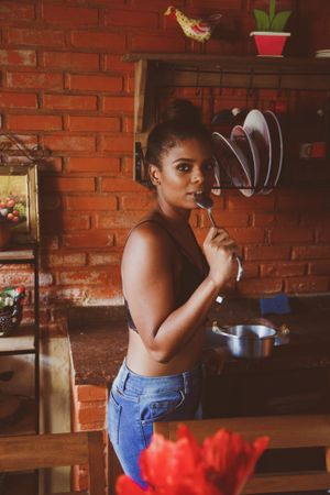 Woman eating in the kitchen