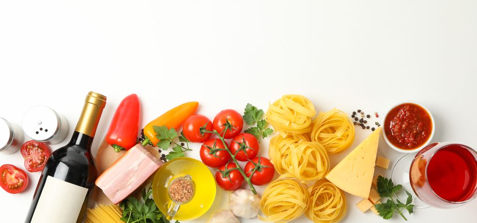 Composition with pasta and ingredients for cooking on plain background, top view