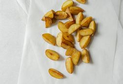 Potato wedges on light background