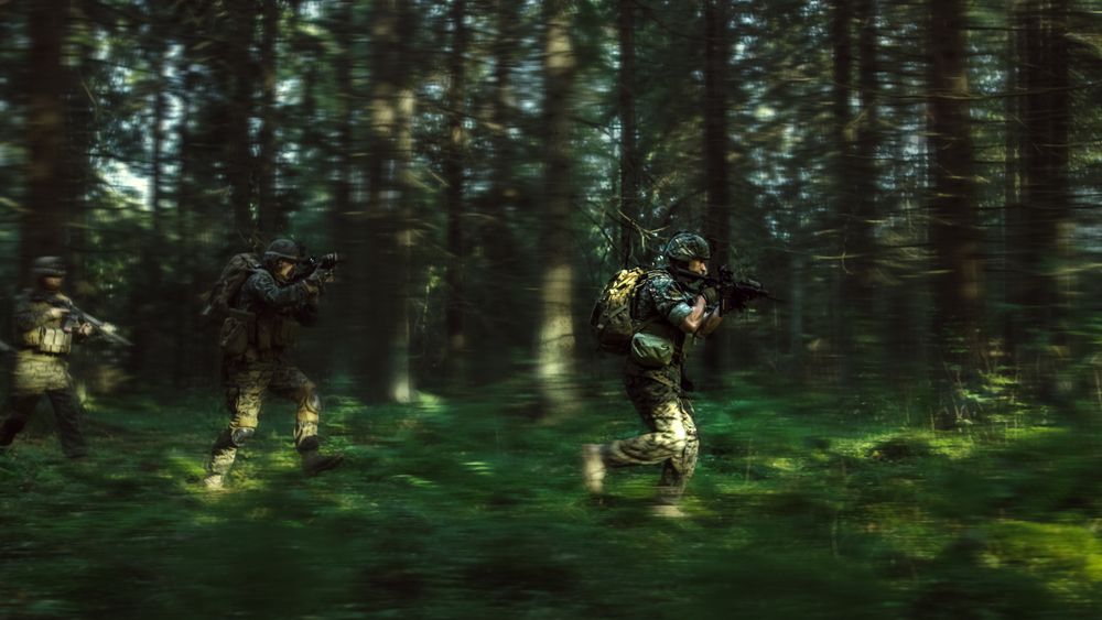 Fully Equipped Soldiers Wearing Camouflage Uniform Attacking Enemy, Rifles in Firing Position.