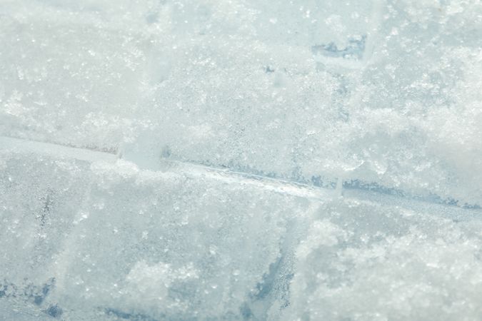 Top view, close up of rows of tightly stacked ice cubes