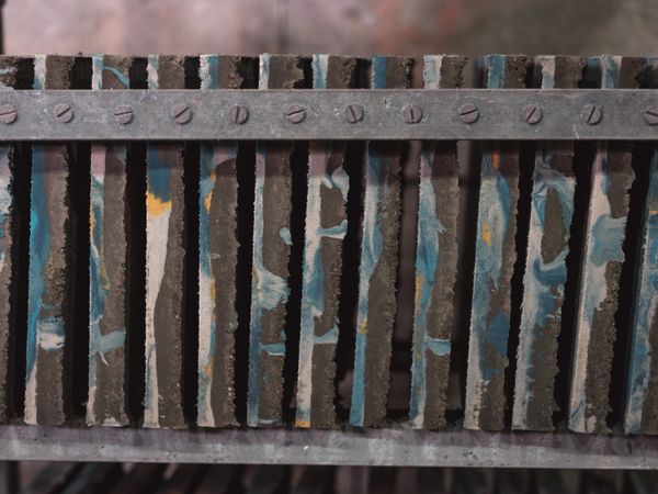 Row of ornamental tiles on shelf