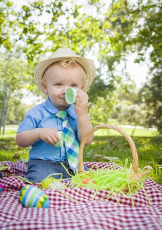 Cute Little Boy Enjoying His Easter Eggs Outside in Park