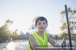 Portrait of a young teen wearing a yellow basketball sleeveless shirt smiling 4B1LE5