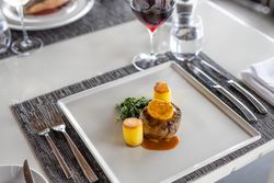 Potatoes, greens and steak at a restaurant