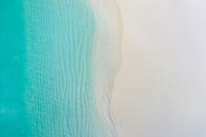 Aerial shot of clear water at a tropical beach