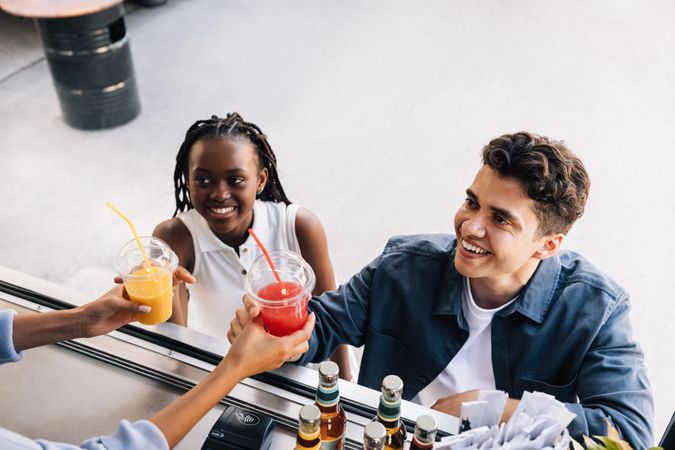 People buying fresh juice from street vendor