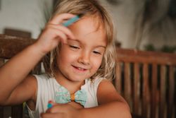 Girl coloring pictures at home