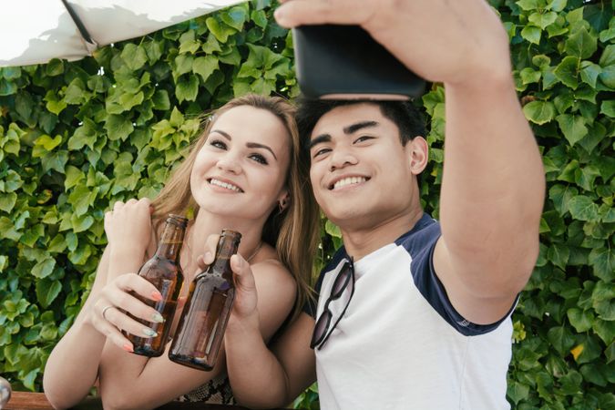 Young couple drinking beer on a sunny day