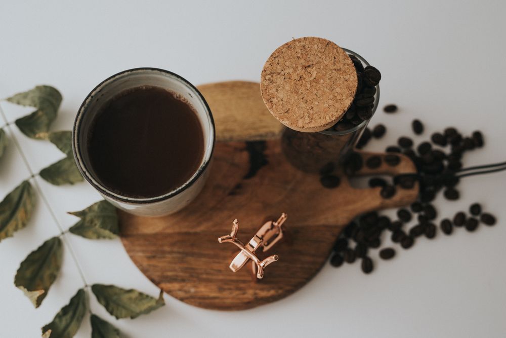 Mug and decorative elements on wooden stand on table