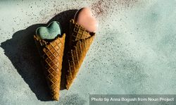 Two ceramic hearts in waffle cones on background with glitter 5nggBM