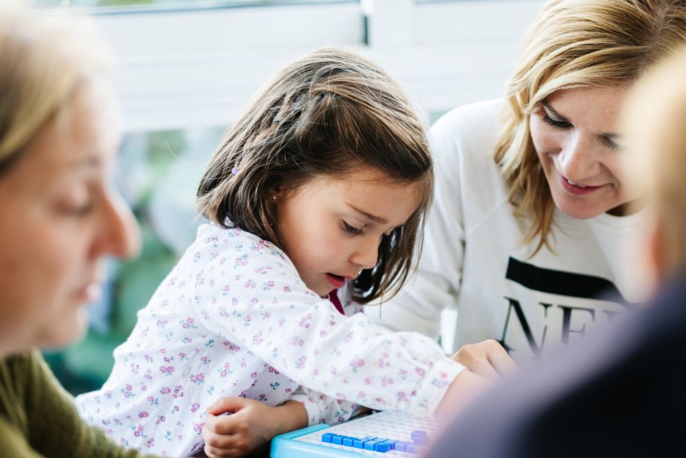 Woman playing board game with daughter and granddaughter