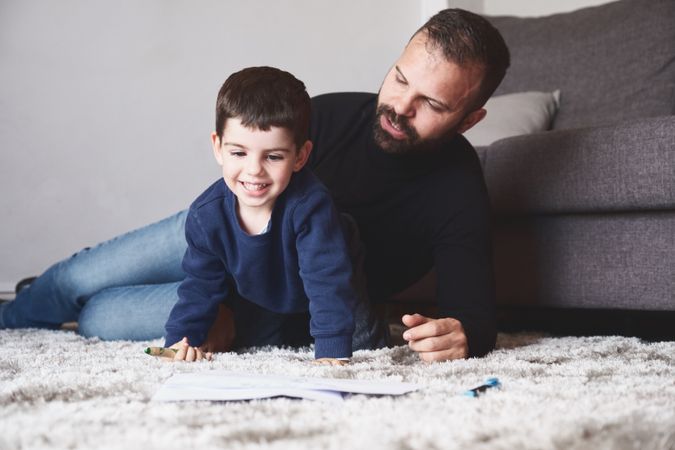 Father and son drawing on floor