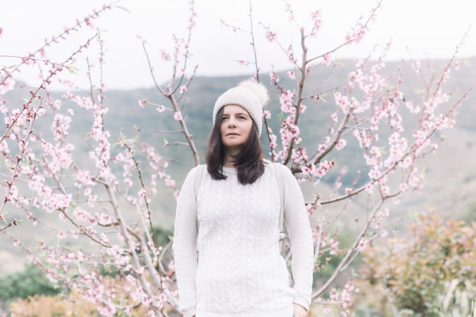 Pensive woman in spring countryside