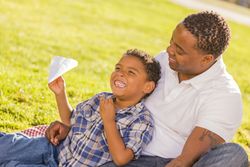 Father and Son Playing with Paper Airplanes