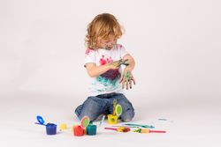 Boy covered with colorful paints