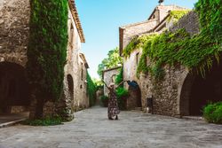 Woman walking in a narrow path in a village