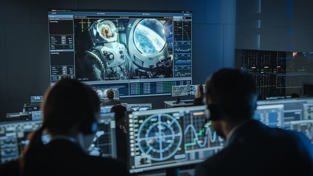 Mission Control Monitors Canine Astronaut in Space. Large Screen Displays Dog in Spacesuit