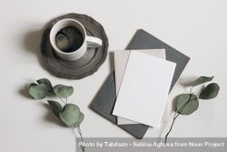 Blank greeting card, invitation mockup, dry eucalyptus tree branches and grey diary with cup of coffee 4Badnd