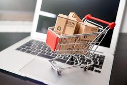 Shopping Cart With Boxes on Laptop Representing Online Shopping Concept