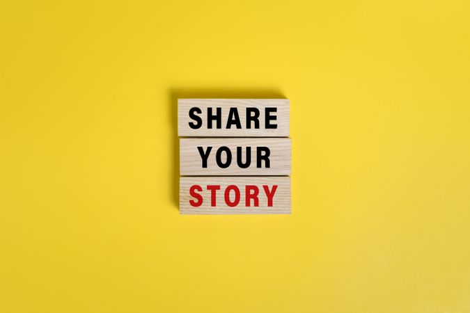 share your story words on wooden blocks isolated on yellow background