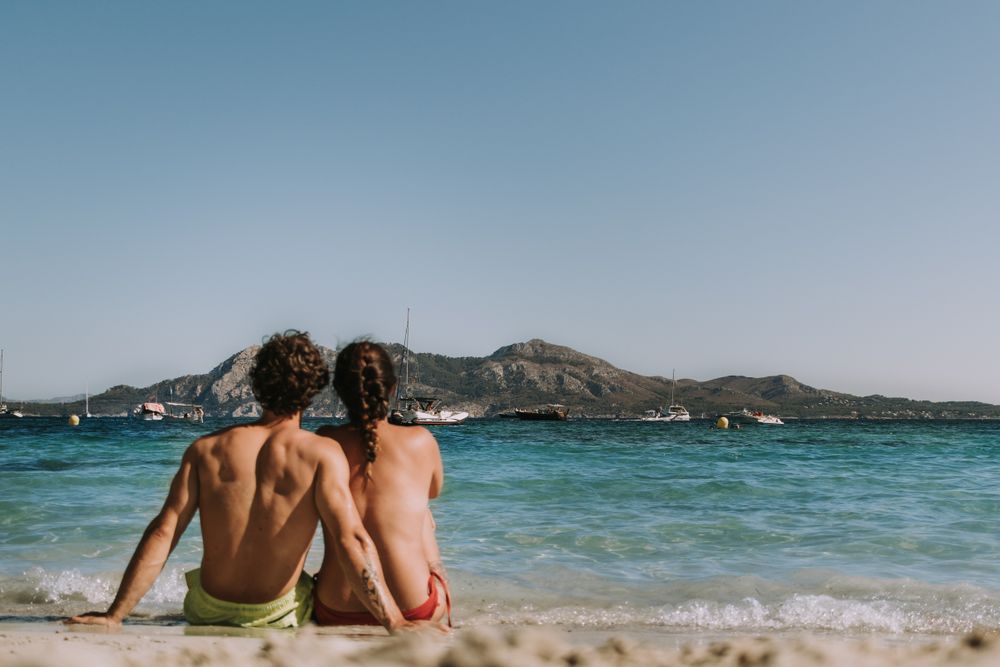 Happy couple hugging by sea