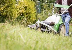 man mowing the lawn with a lawnmower