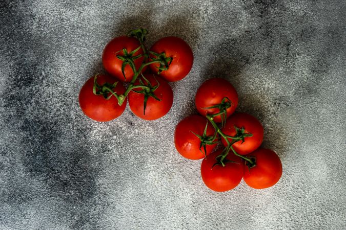 Fresh tomatoes on the vine on grey counter