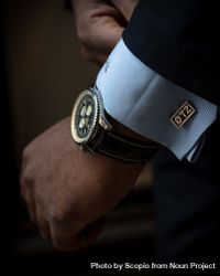 Cropped image of man's hand with gold round analog watch 4OX3gb
