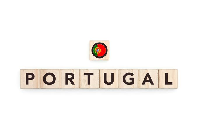 Wooden blocks bearing the name and flag of Portugal. Portuguese, Atlantic and European Culture, national identity, travel, and geography in a copy space design.
