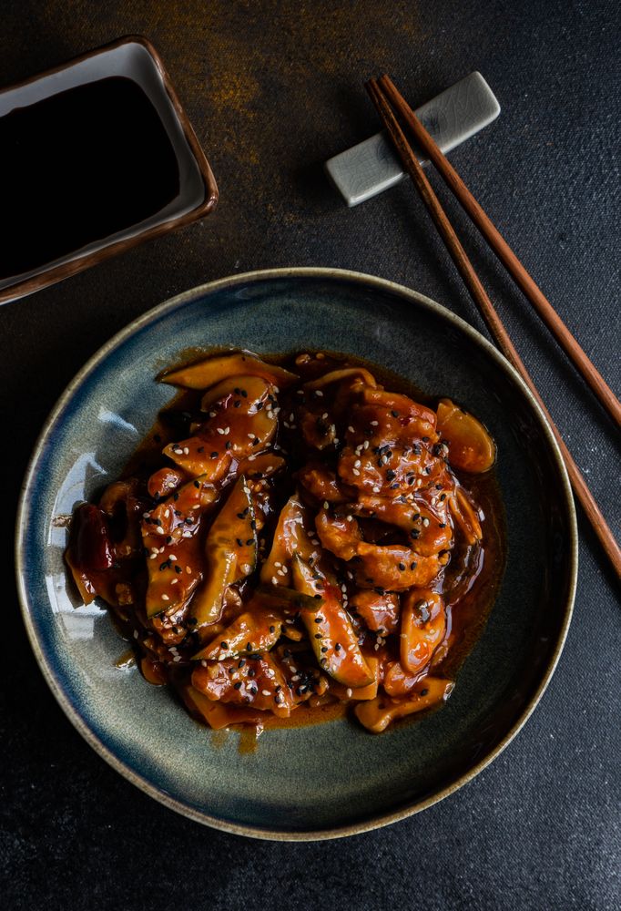 Traditional Chinese sweet and sour pork served with chopsticks