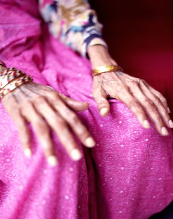 Older woman's hands resting on knees